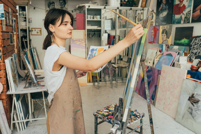 Woman painting in artists studio